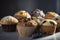 Freshly baked muffins with a variety of flavors and toppings, including blueberry, banana nut, and chocolate chip. 